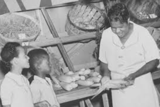 Nannie Helen Burroughs (1879–1961) with children in a market