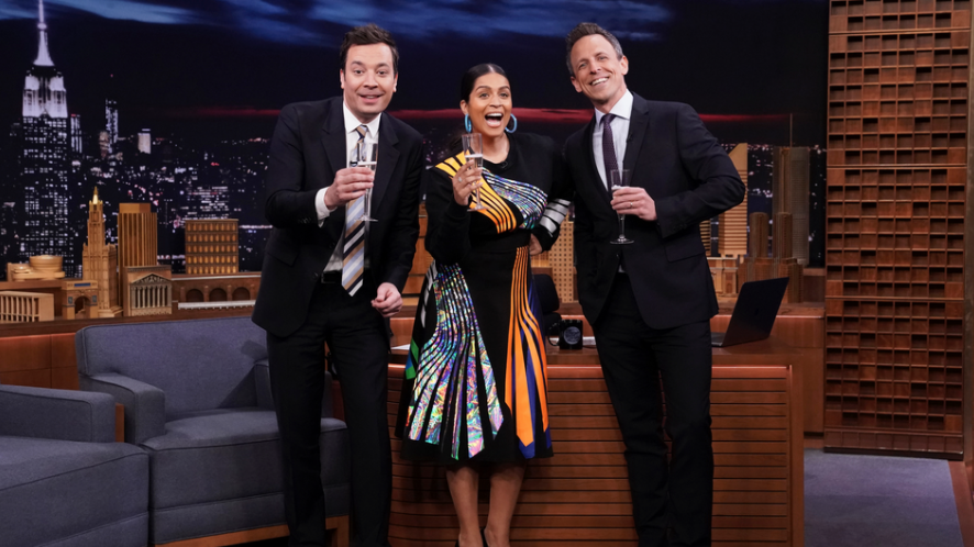 Jimmy Fallon, Lilly Singh and Seth Meyers posing with champagne at the late night set.